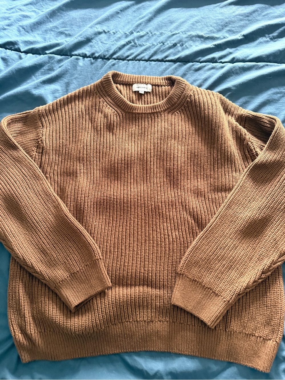 Abbreviated fisherman knit sweater